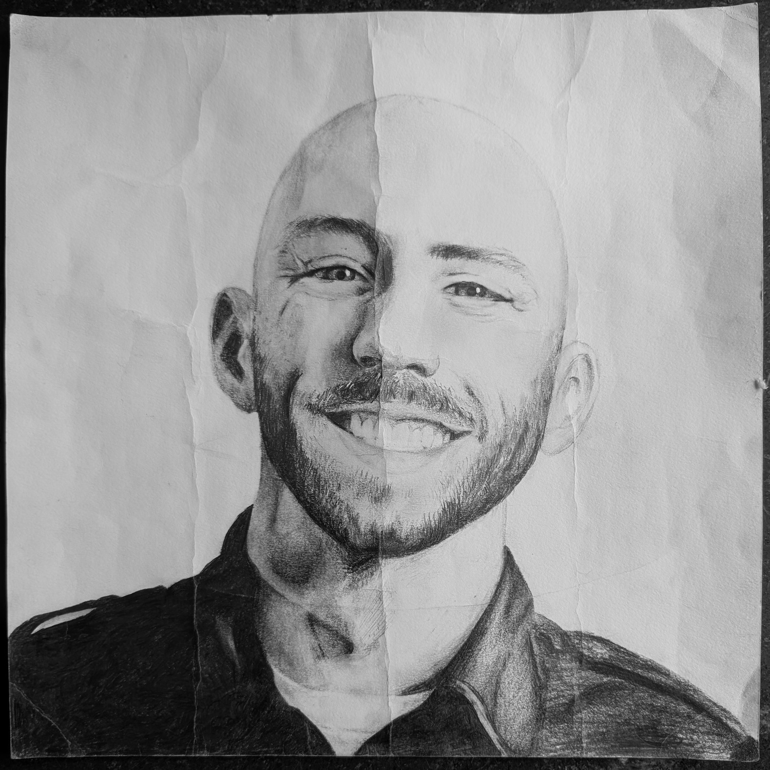Pencil drawing of Justin Owings on creased paper